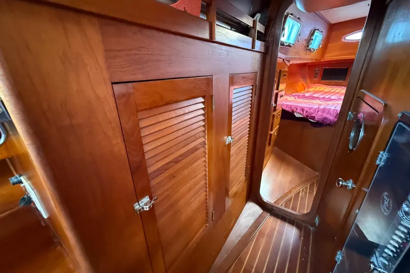 Slide: The Image of 1979 Gulfstar 43 MK II yacht interior with wooden cabinetry and cozy sleeping area. - 37