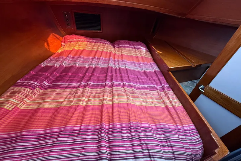 Slide: The Image of Cozy cabin interior of 1979 Gulfstar 43 MK II with striped bedding. - 40