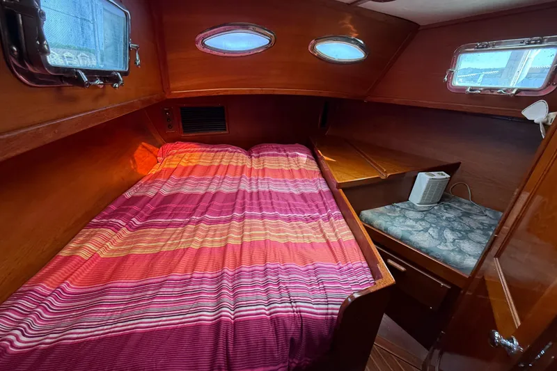 Slide: The Image of Cozy cabin interior of 1979 Gulfstar 43 MK II with striped bedding and wooden finish. - 41