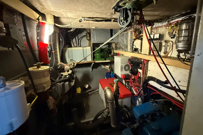 Slide: The Image of Engine room of a 1979 Gulfstar 43 MK II sailboat, showcasing mechanical components and wiring. - 42
