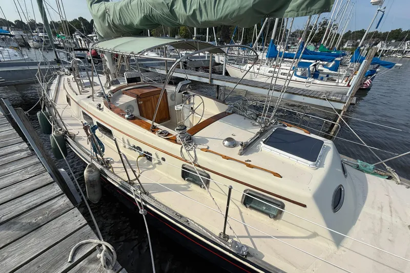 Slide: The Image of 1979 Gulfstar 43 MK II sailboat docked at marina, featuring classic design and rigging. - 5