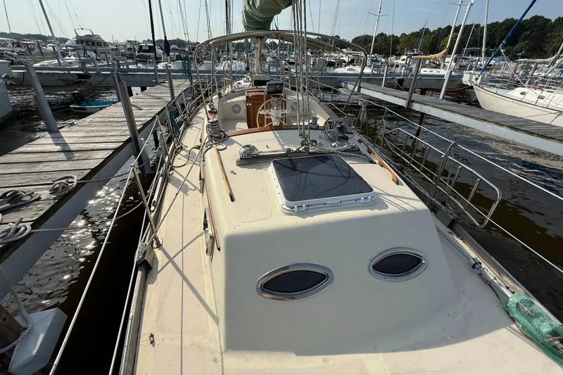 Slide: The Image of 1979 Gulfstar 43 MK II sailboat docked at marina, showcasing deck and rigging. - 9