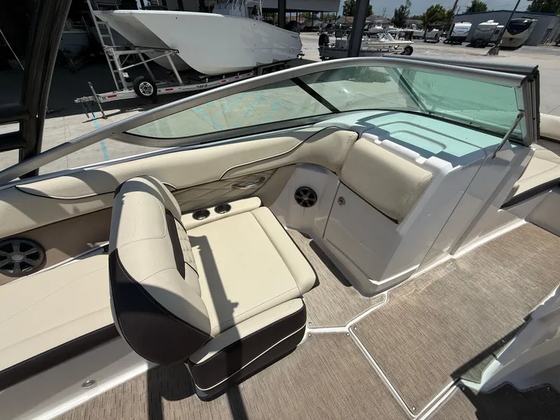 Slide: The Image of 2018 Regal 22 FasDeck boat interior with beige seating and glass windshield. - 10