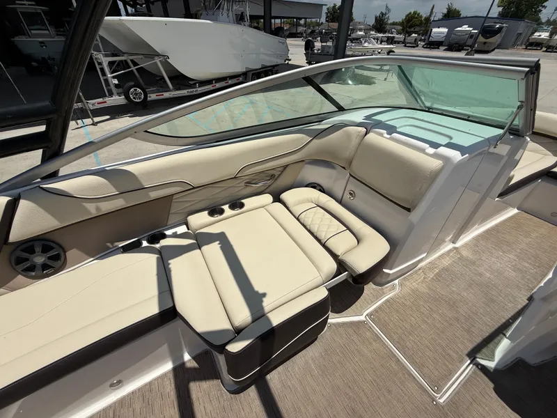 Slide: The Image of 2018 Regal 22 FasDeck boat interior with beige seating and cup holders. - 11