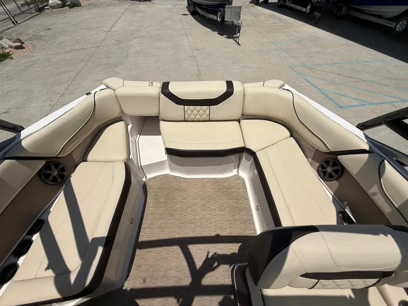 Slide: The Image of 2018 Regal 22 FasDeck boat interior with beige seating and cup holders. - 14
