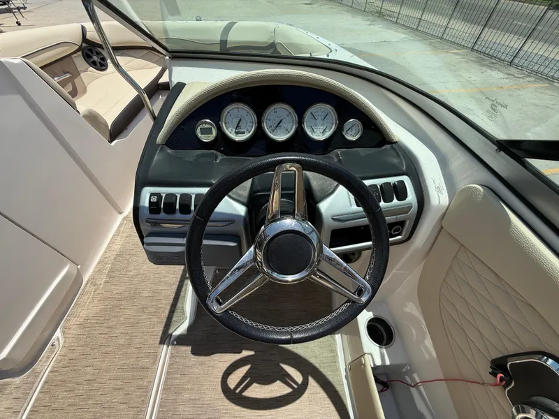 Slide: The Image of 2018 Regal 22 FasDeck boat dashboard with steering wheel and gauges. - 16
