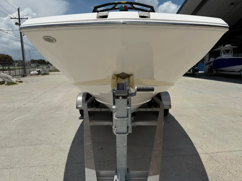 Slide: The Image of 2018 Regal 22 FasDeck boat on trailer, front view in outdoor setting. - 3
