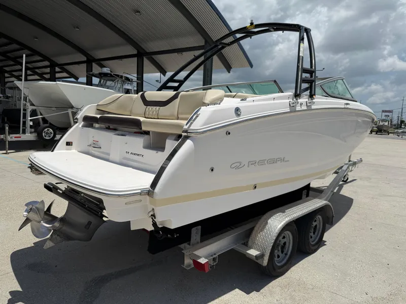 Slide: The Image of 2018 Regal 22 FasDeck boat on trailer under a covered area, rear view. - 7