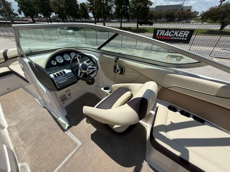 Slide: The Image of 2018 Regal 22 FasDeck boat interior with steering wheel and dashboard controls. - 9