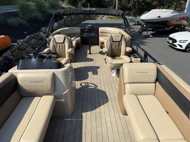 Slide: The Image of 2022 Viaggio L22U pontoon boat with beige seating and sleek design. - 10