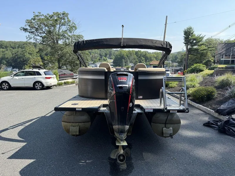 Slide: The Image of 2022 Viaggio L22U pontoon boat with Mercury outboard motor, parked on a sunny day. - 5