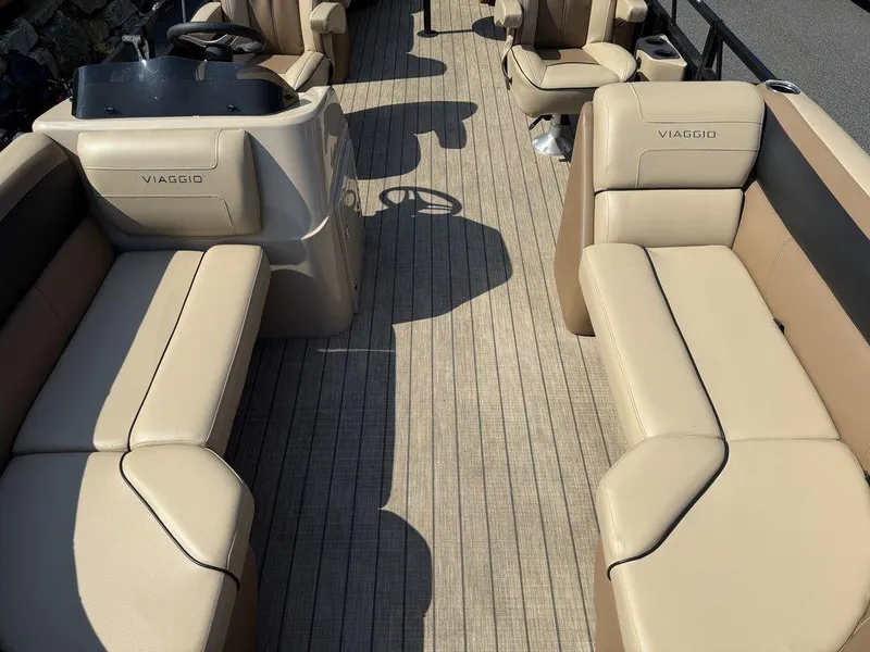Slide: The Image of 2022 Viaggio L22U boat interior with beige seating and steering console. - 7