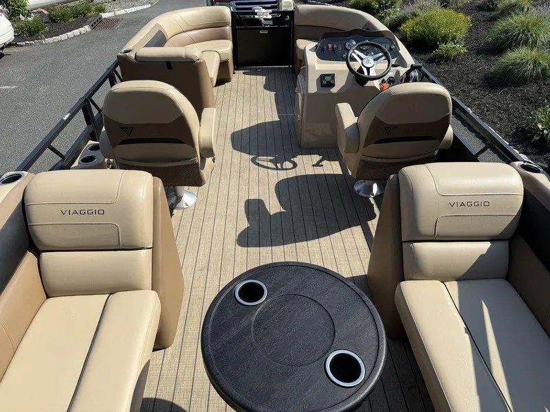 Slide: The Image of Luxurious 2022 Viaggio L22U pontoon boat interior with plush seating and steering console. - 9