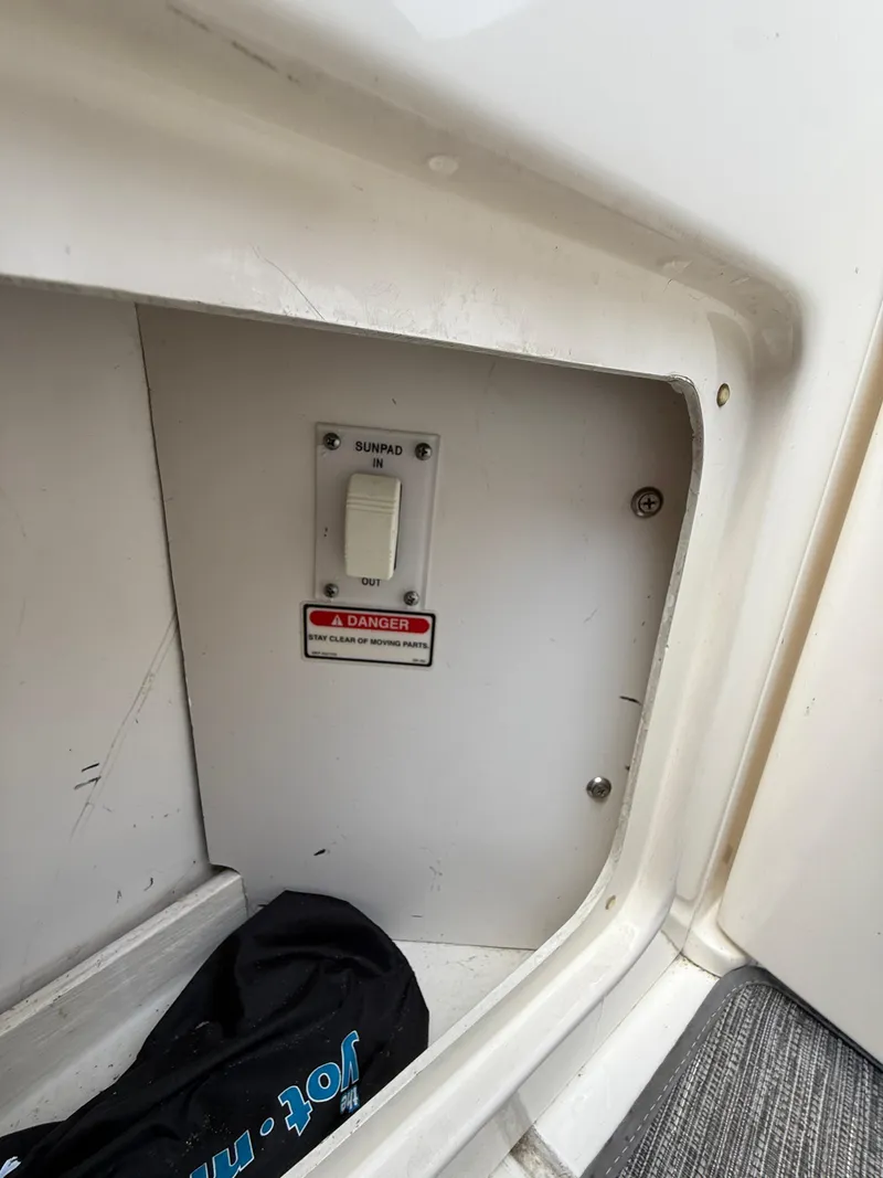 Slide: The Image of Sunpad control switch on 2000 Sea Ray 460 Sundancer boat with safety warning label. - 15