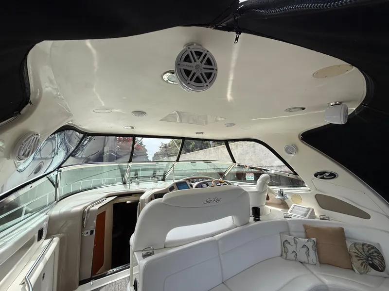 Slide: The Image of Interior of 2000 Sea Ray 460 Sundancer yacht with white seating and modern dashboard. - 16