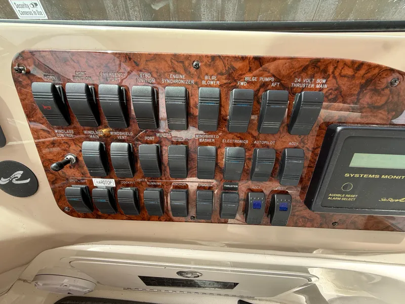 Slide: The Image of Control panel of a 2000 Sea Ray 460 Sundancer boat with labeled switches and systems monitor. - 18