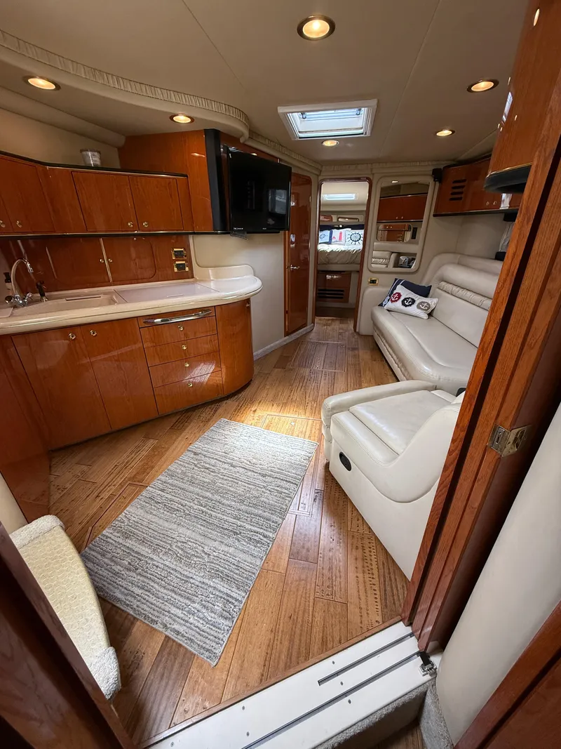 Slide: The Image of Luxurious interior of a 2000 Sea Ray 460 Sundancer yacht with wood flooring and plush seating. - 21