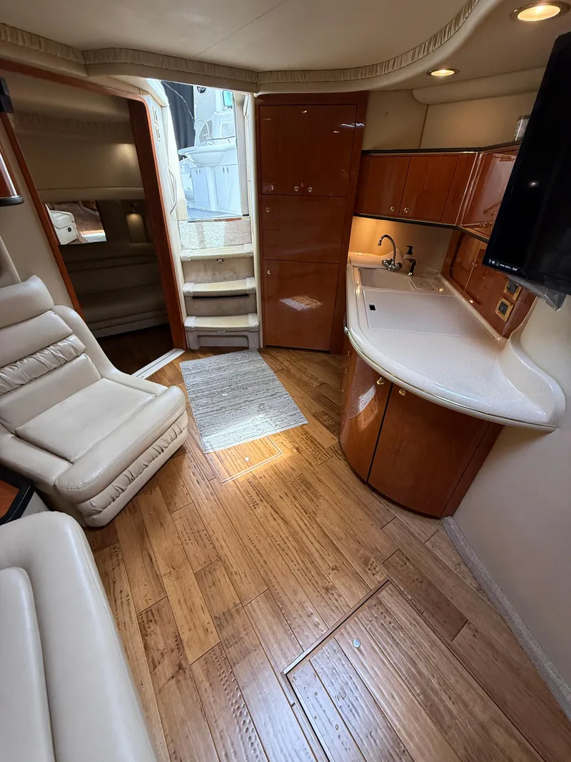 Slide: The Image of Interior of 2000 Sea Ray 460 Sundancer yacht with wood flooring and modern amenities. - 22