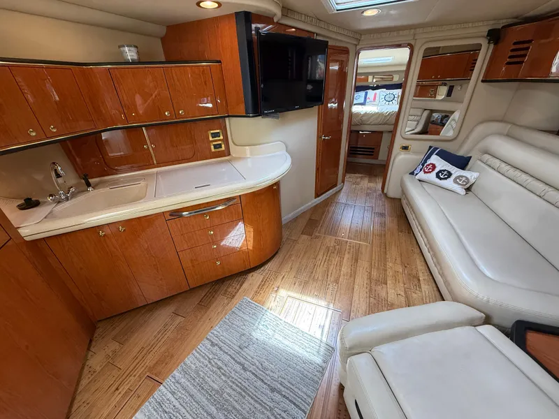 Slide: The Image of Luxurious interior of 2000 Sea Ray 460 Sundancer yacht with wood cabinetry and plush seating. - 23