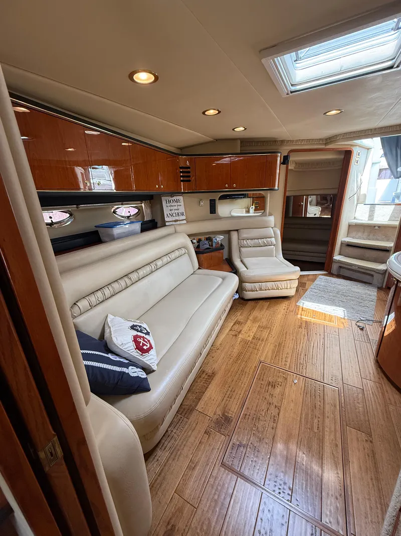 Slide: The Image of Luxurious interior of 2000 Sea Ray 460 Sundancer yacht with elegant seating and wood flooring. - 24