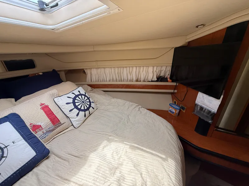 Slide: The Image of Cozy cabin interior of 2000 Sea Ray 460 Sundancer with nautical-themed bedding. - 27