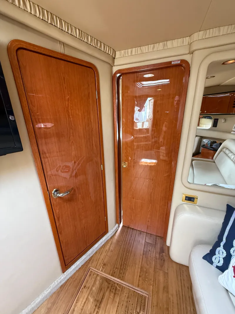 Slide: The Image of Interior of 2000 Sea Ray 460 Sundancer yacht with wooden doors and luxurious seating. - 29