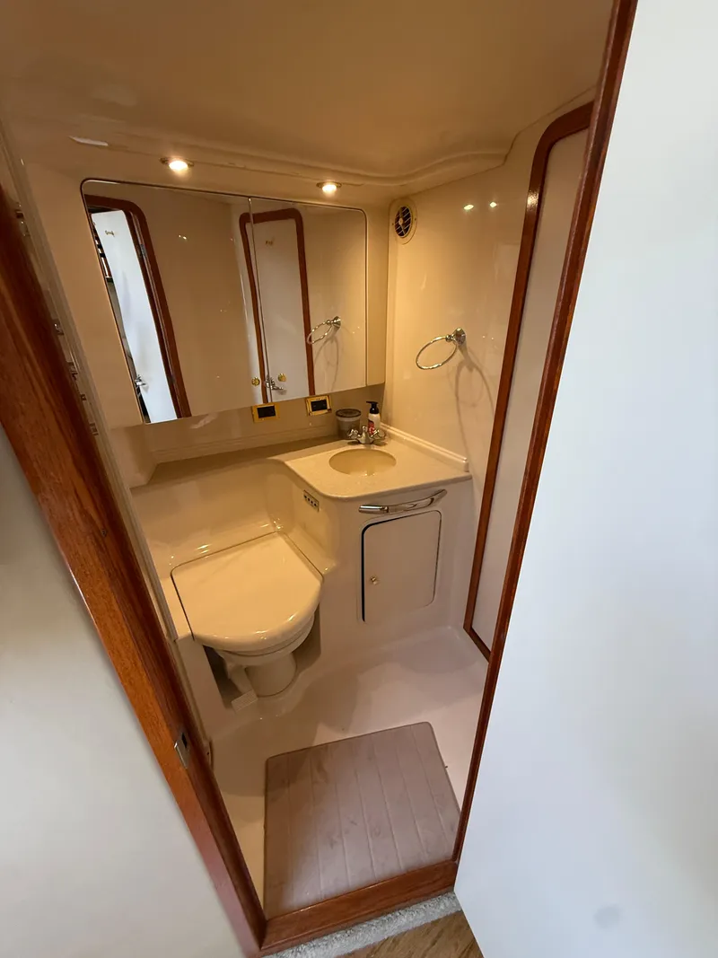 Slide: The Image of Bathroom interior of 2000 Sea Ray 460 Sundancer yacht, featuring sink and toilet. - 30