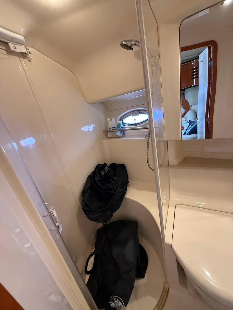 Slide: The Image of Interior of 2000 Sea Ray 460 Sundancer bathroom with shower and storage bags. - 31