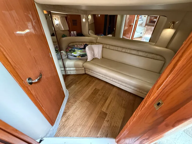 Slide: The Image of Interior of 2000 Sea Ray 460 Sundancer yacht with beige leather seating and wooden flooring. - 32