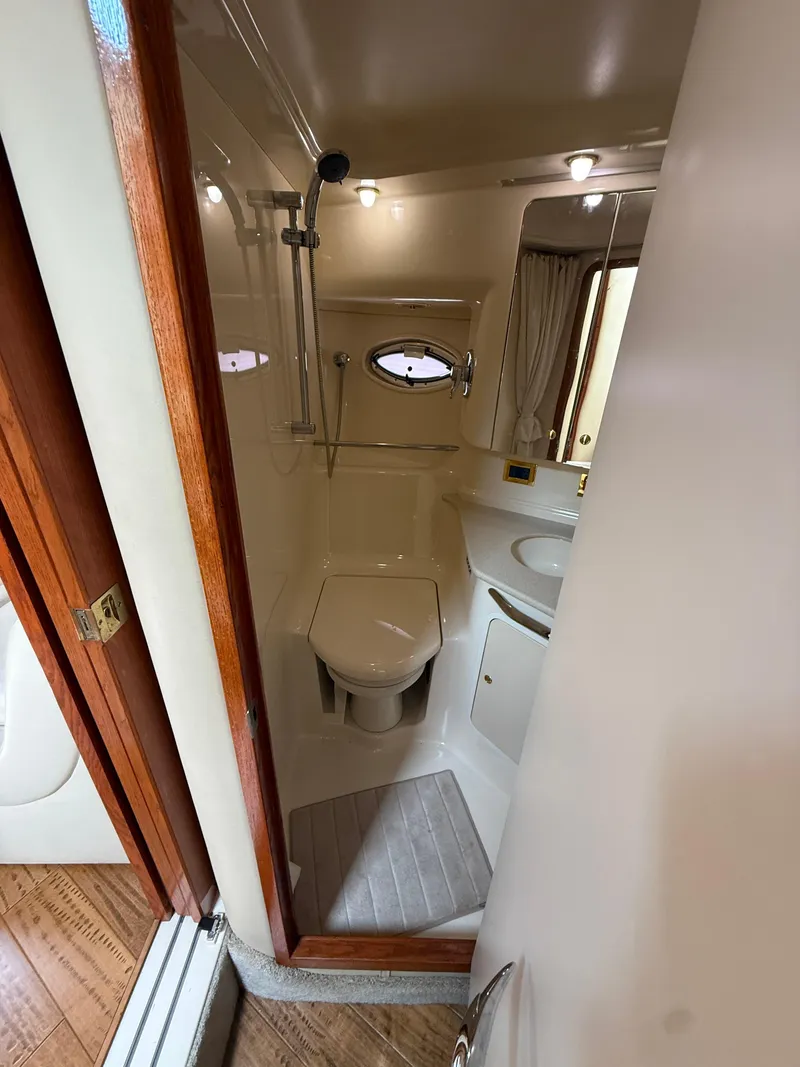 Slide: The Image of Bathroom interior of 2000 Sea Ray 460 Sundancer yacht, featuring shower and toilet. - 33