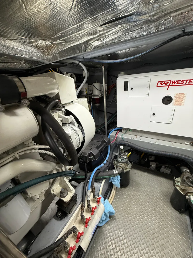 Slide: The Image of Engine room of 2000 Sea Ray 460 Sundancer with generator and mechanical components. - 36