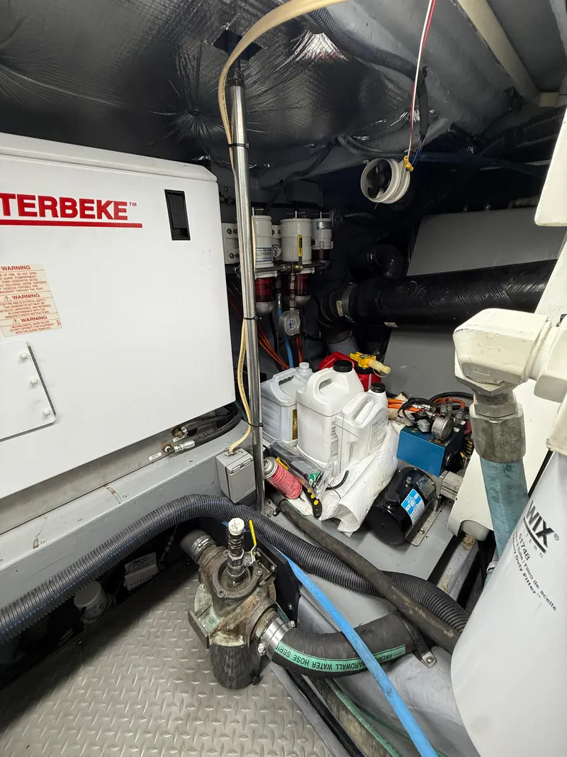 Slide: The Image of Engine room of a 2000 Sea Ray 460 Sundancer with equipment and hoses. - 37