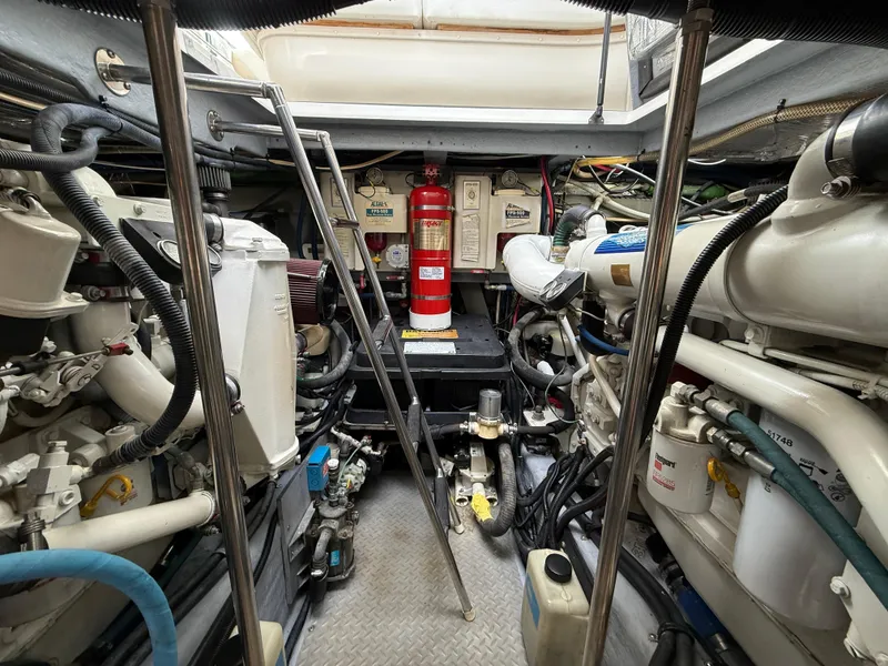 Slide: The Image of Engine room of a 2000 Sea Ray 460 Sundancer, featuring mechanical components and fire extinguisher. - 38