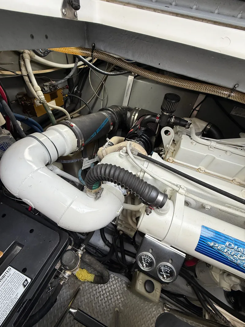 Slide: The Image of Engine compartment of a 2000 Sea Ray 460 Sundancer boat, showing mechanical components. - 39