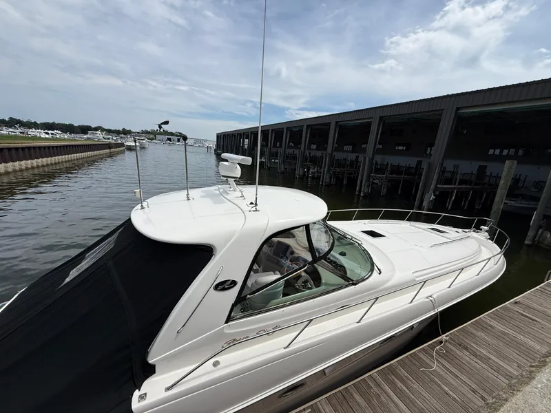 Slide: The Image of 2000 Sea Ray 460 Sundancer yacht docked at marina under cloudy sky. - 42
