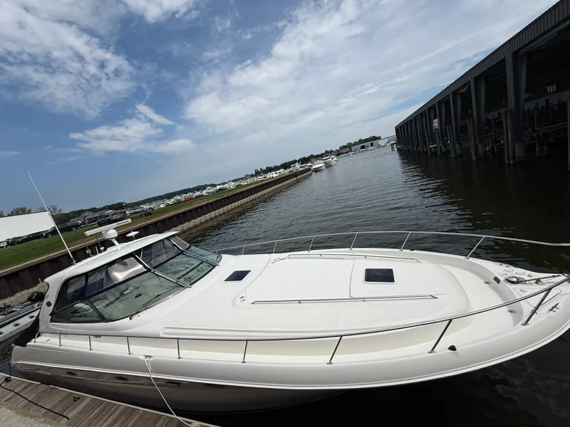 Slide: The Image of 2000 Sea Ray 460 Sundancer yacht docked at marina under cloudy sky. - 43