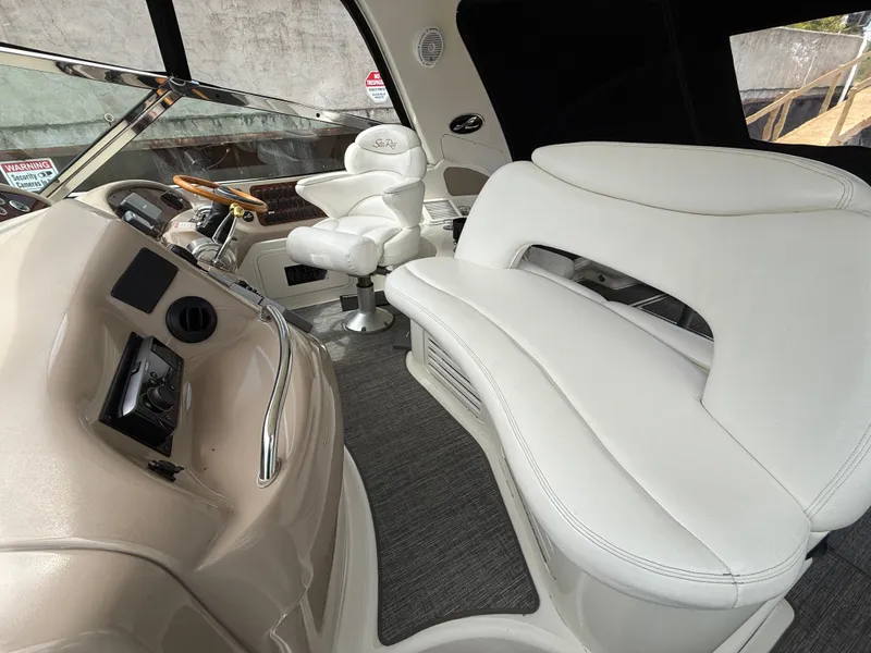 Slide: The Image of Interior of 2000 Sea Ray 460 Sundancer yacht with white leather seating and helm. - 8