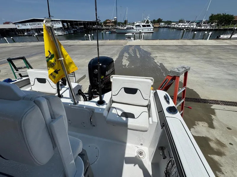 Slide: The Image of 2020 Wellcraft 182 Fisherman boat at marina, featuring outboard motor and dockside view. - 12
