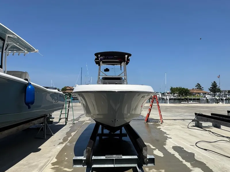 Slide: The Image of 2020 Wellcraft 182 Fisherman boat on trailer at marina under clear blue sky. - 6