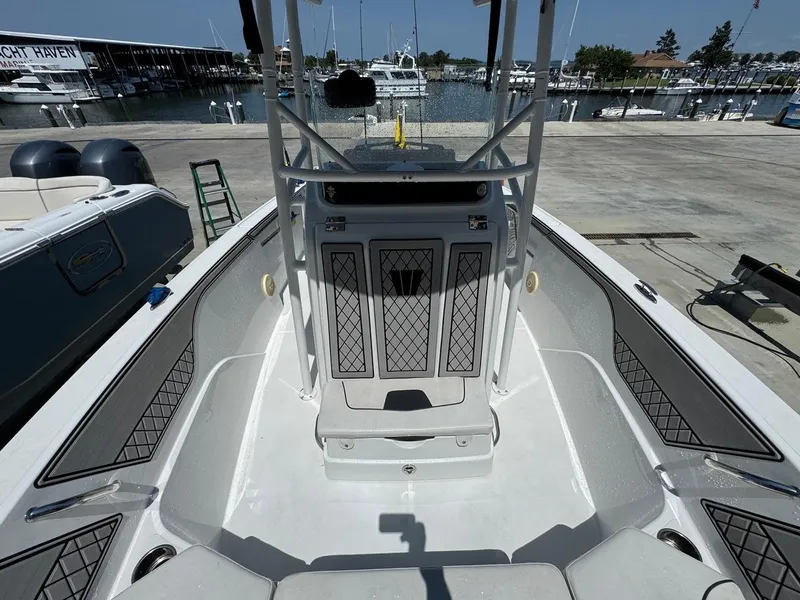 Slide: The Image of 2020 Wellcraft 182 Fisherman boat interior at marina, showcasing seating and storage. - 8