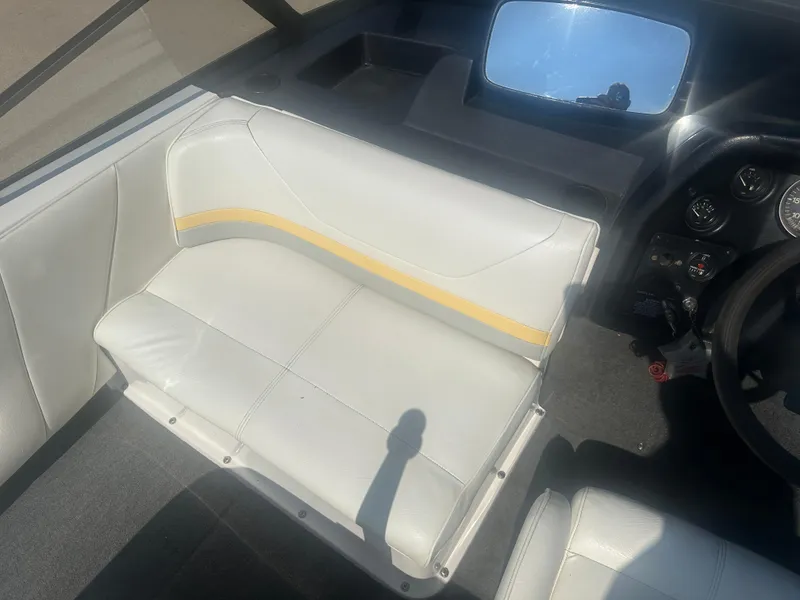 Slide: The Image of 1990 MasterCraft Prostar190 interior with white seating and dashboard view. - 12