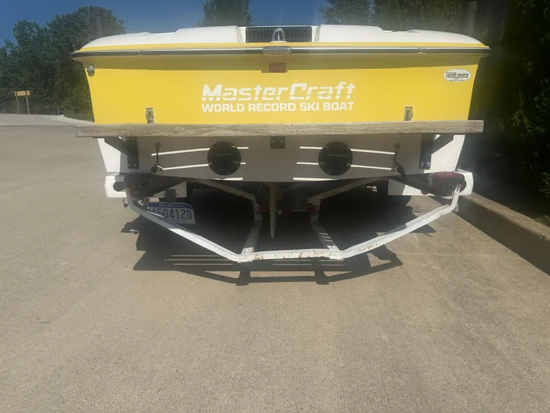 Slide: The Image of 1990 MasterCraft Prostar190 ski boat, yellow, rear view on trailer. - 3