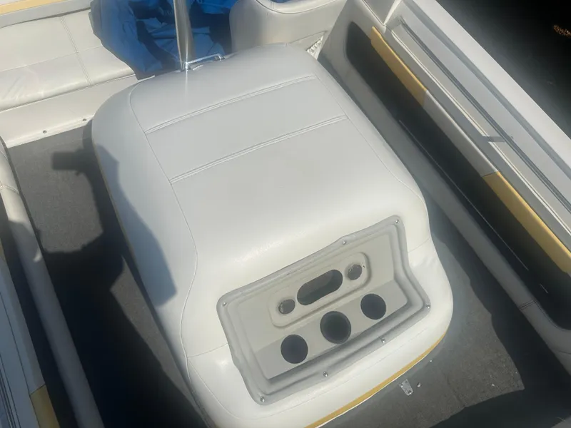 Slide: The Image of 1990 MasterCraft Prostar190 boat interior with white seating and cup holders. - 5