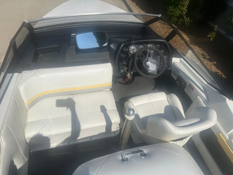 Slide: The Image of 1990 MasterCraft Prostar190 boat interior with white seating and steering wheel. - 8
