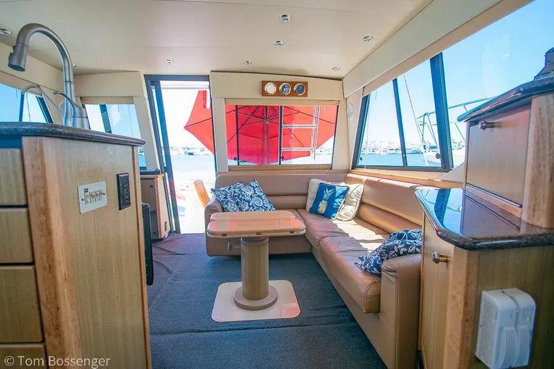 Slide: The Image of Luxurious interior of 2002 Bayliner 3988 Command Bridge Motoryacht with plush seating and nautical decor. - 10