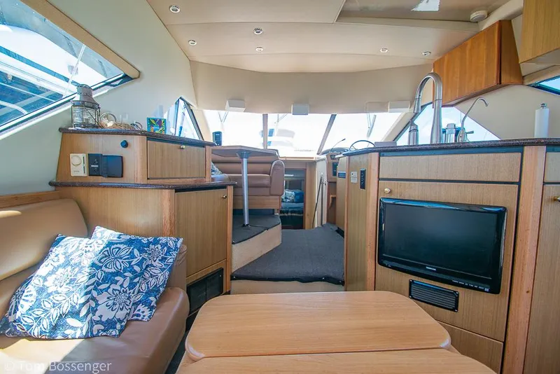 Slide: The Image of Interior of 2002 Bayliner 3988 Command Bridge Motoryacht with modern amenities and cozy seating. - 12