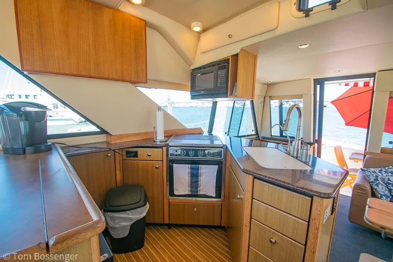 Slide: The Image of Interior of 2002 Bayliner 3988 Command Bridge Motoryacht with modern kitchen and ocean view. - 15