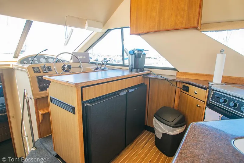 Slide: The Image of 2002 Bayliner 3988 Command Bridge Motoryacht interior with helm, kitchen, and appliances. - 16
