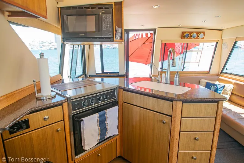 Slide: The Image of Interior of 2002 Bayliner 3988 Command Bridge Motoryacht kitchen with stove and sink. - 17
