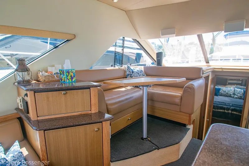Slide: The Image of Interior of 2002 Bayliner 3988 Command Bridge Motoryacht with cozy seating and table. - 19